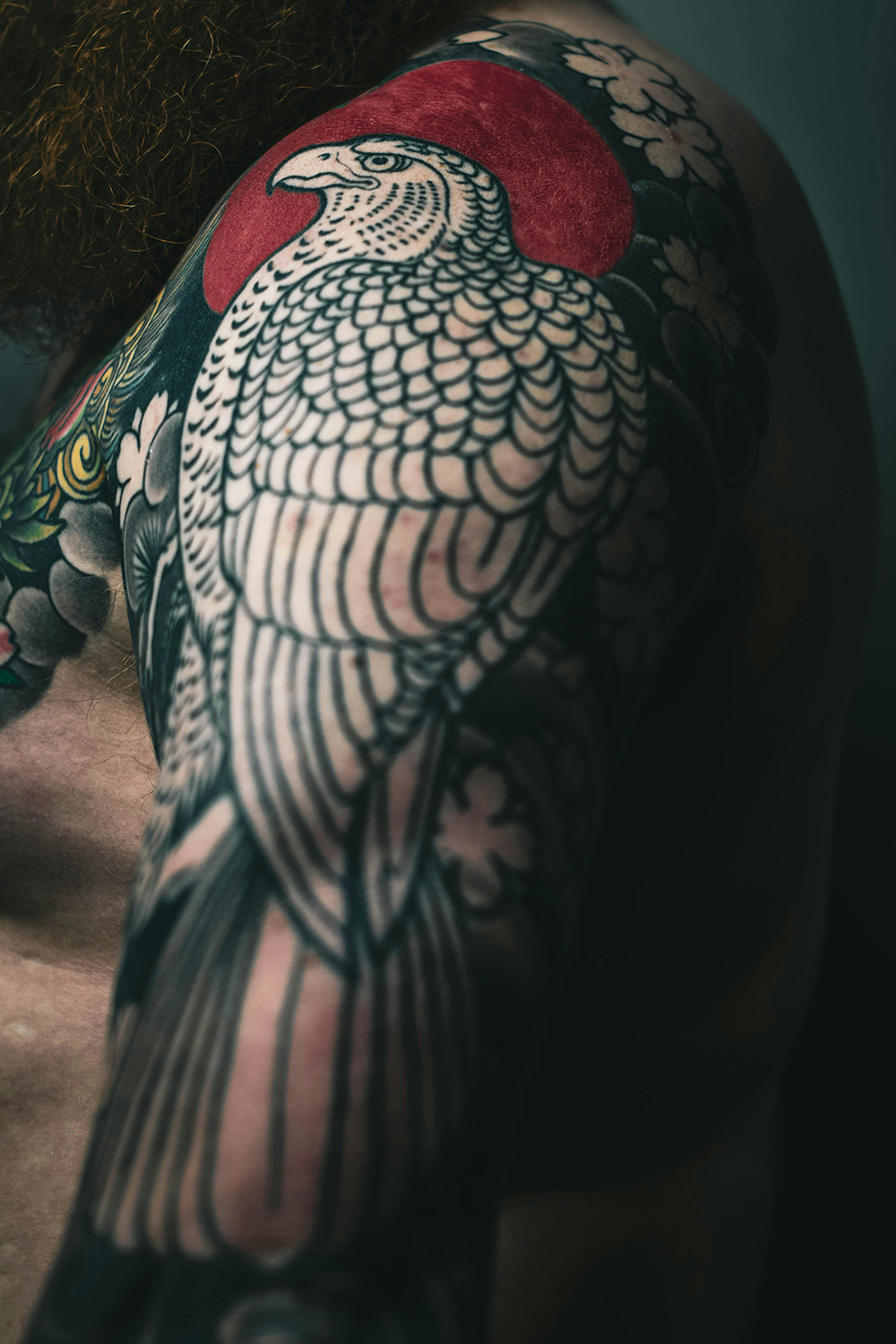 Bird of prey tattoo on a mans shoulder.
